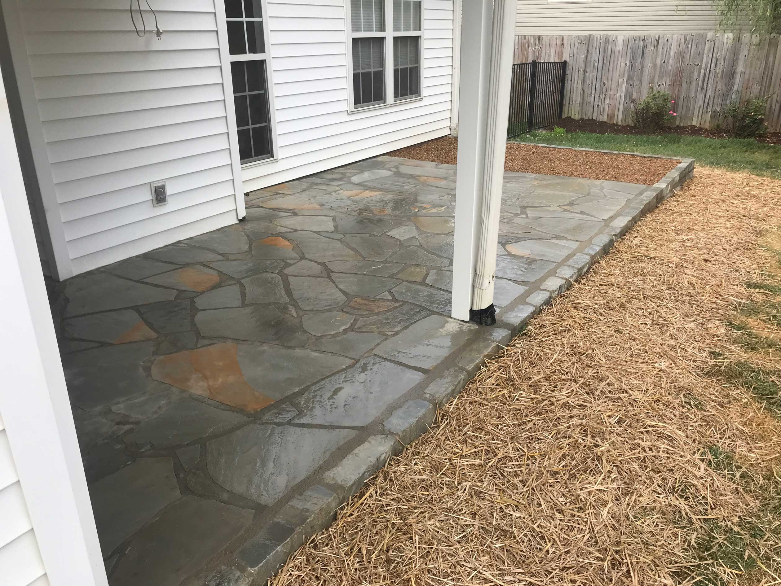 Natural stone walkway built through a sloped yard Natural stone walkway built through a sloped yard