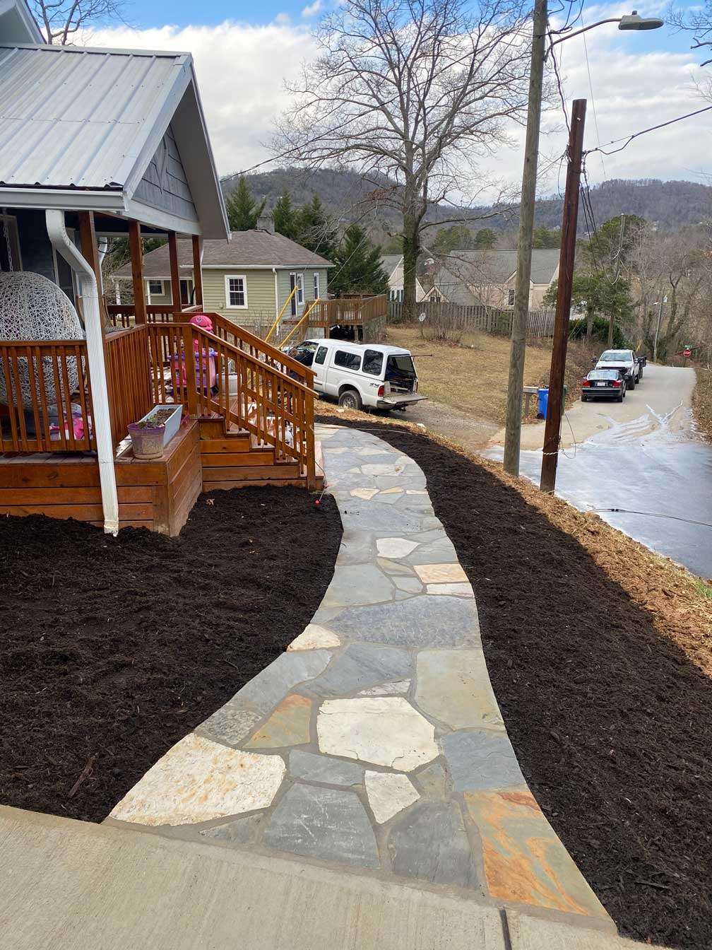 Curved stone walkway connecting different yard elevations Curved stone walkway connecting different yard elevations