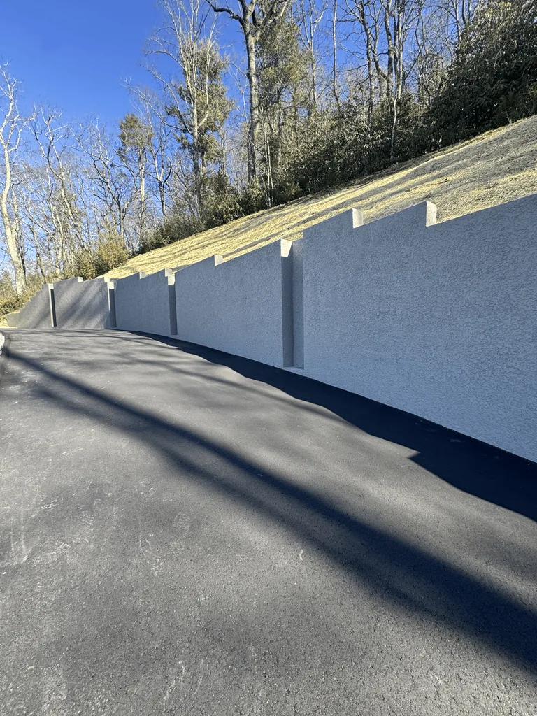 Finished masonry wall beside a residential driveway Finished masonry wall beside a residential driveway