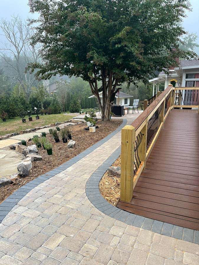 Laughter Family Hardscapes Hardscaping Services Buncombe County NC -06 The image depicts a elegantly designed stone walking path and wood walking bridge.